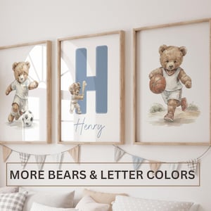 May include: Three framed wall art prints featuring watercolour-style teddy bears playing sports. The left print shows a bear playing football, the centre print features a large blue letter H with a bear holding a bat and the name Henry, and the right print shows a bear dribbling a basketball.