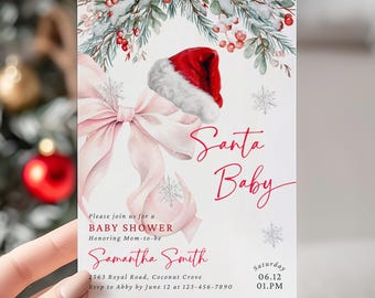 May include: A baby shower invitation with a Santa Baby theme. The invitation, held by a person, features a red Santa hat, a pink bow, and the words "Santa Baby" in red script. The invitation also includes the name Samantha Smith and event details.