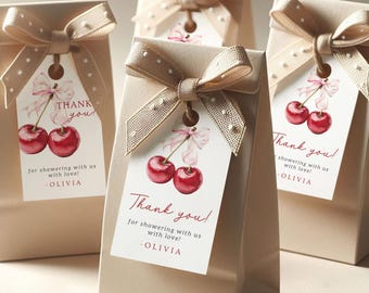 May include: Four small, beige gift bags with brown ribbon bows and white polka dots. Each bag has a white tag with a red cherry illustration and the text "Thank you! for showering with us with love! -OLIVIA".