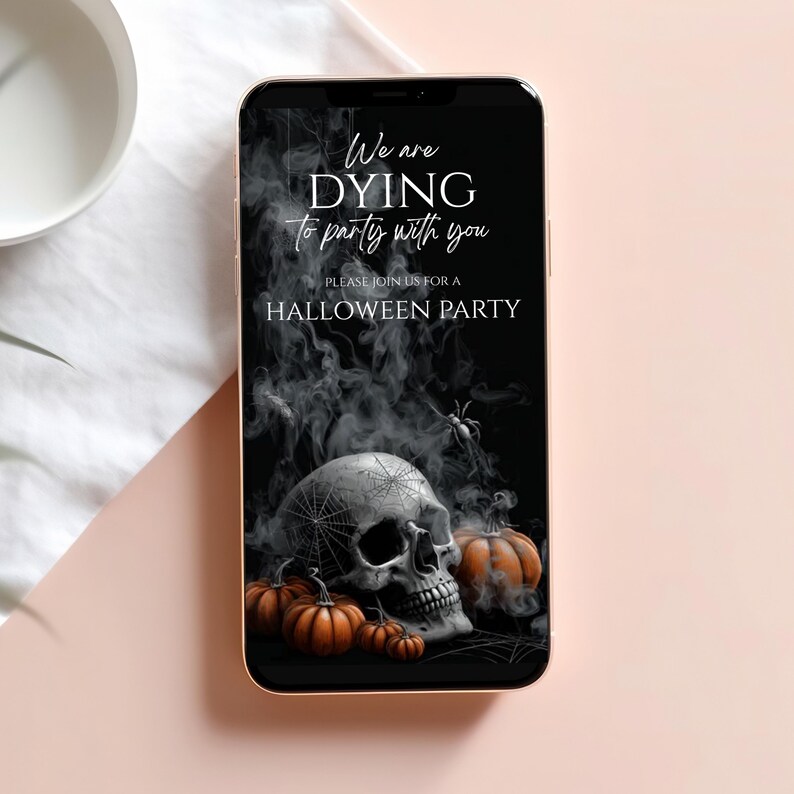 May include: A smartphone displays a Halloween party invitation. The black background features a skull, pumpkins, and spiderwebs. Text reads, "We are dying to party with you. Please join us for a Halloween party."