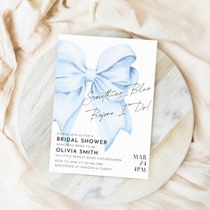 May include: A blue bridal shower invitation with a watercolor illustration of a blue bow and the text "Something Blue Before I Do!"  Please join us for a bridal shower honoring bride-to-be Olivia Smith. 123 Little Peanut Road Chicago, 60556. RSVP to Jane at 123-456-7890. Registered at Amazon & Target.  Mar 24, 4PM.