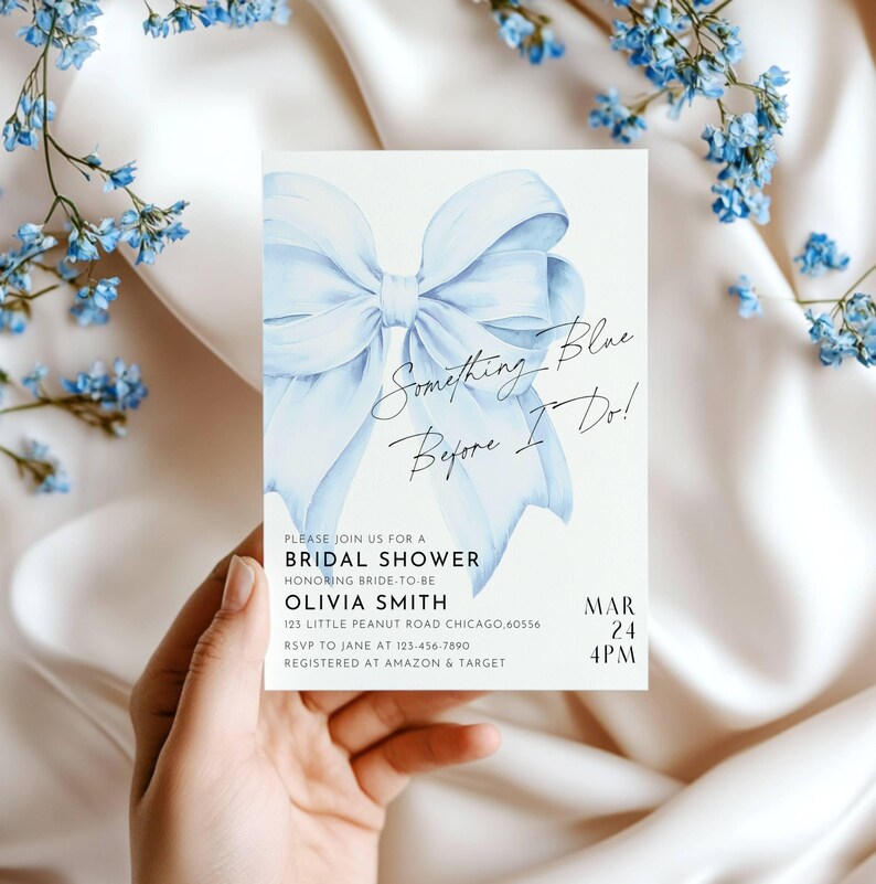 May include: A blue watercolor bow with the text "Something Blue Before I Do!" on a white background. The text below the bow reads "Please join us for a Bridal Shower honoring bride-to-be Olivia Smith 125 Little Peanut Road Chicago, 60556 RSVP to Jane at 123-456-7890 Registered at Amazon & Target Mar 24 4PM".