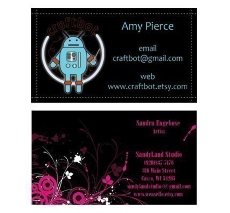 May include: Two business cards, one with a black background and a cartoon robot logo with the text "craftbot" and contact information for Amy Pierce, and the other with a black background and a floral design with contact information for Sandra Engebose, Artist, Sandy Land Studio.