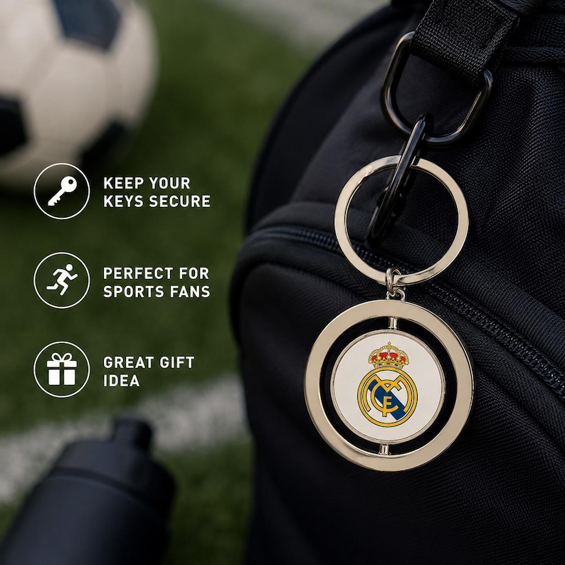 May include: A silver keyring with a circular pendant displaying the Real Madrid team logo. The keyring is attached to a black bag. Text on the left reads: "KEEP YOUR KEYS SECURE", "GREAT GIFT IDEA".