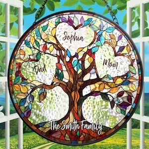May include: A stained glass window hanging with a colorful tree design. The tree has three hearts with the names "Sophia", "Mom", and "Dad" written inside. The text "The Smith Family" is at the bottom of the tree.