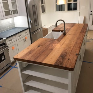 Butcher block countertop with massive wooden top in a luxury kitchen room