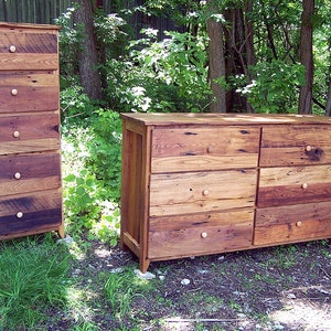 May include: Two wooden chests of drawers with multiple drawers and simple knob pulls. The chests are made of reclaimed wood with a rustic finish.
