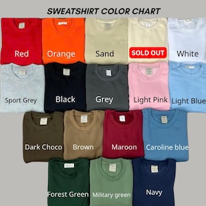 May include: A sweatshirt color chart displaying seventeen folded crewneck sweatshirts in various colors including red, orange, sand, white, sport grey, black, grey, light pink, light blue, dark choco, brown, maroon, caroline blue, forest green, military green, and navy.