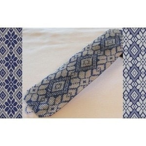 May include: A blue and white beaded bracelet with a geometric pattern. The bracelet is made with small seed beads and has a woven design.