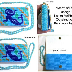 May include: A blue beaded purse with a mermaid design. The purse has a gold chain strap and a white lining. The text "Mermaid Mural" is on the side of the purse. The text "design by Lesha McPhearson Construction and Beadwork by Diana" is also on the side of the purse.