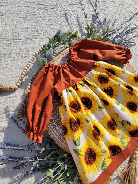 sunflower long sleeve dress We have a theory that if we all collectively wear the sunniest prints, we  might usher in more sunshine....  Testing this theory with the Suzanne  Sunflower Dress, and this print is also available on