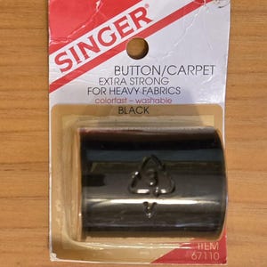 May include: A package of black Singer button/carpet thread. The packaging is white and red with the Singer logo and product information. The thread is extra strong and colorfast. Item 67110.