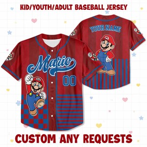 May include: A red and blue baseball jersey featuring a graphic of Mario, the text Mario, the number 00, and the text Your Name. The front has a button-down closure, while the back displays the character and customizable name text.