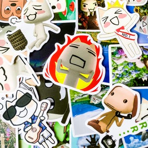 May include: A collection of colorful stickers featuring cartoon characters with various expressions. The stickers are printed on white paper and have a glossy finish. Some of the characters are wearing hats, sunglasses, and other accessories. The stickers are perfect for adding a touch of fun and personality to any surface.