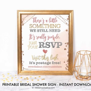 May include: Printable bridal shower sign with gold glitter and pink watercolour background. The sign says "There's a little something we still need. It's really simple. Just RSVP your [heart] Visit this link. It's postage free! www.theknot.com/yoursitehere"