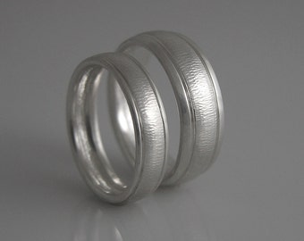 Wedding ring set in white gold. Comfort fit. Textured, hammered  5mm and 7mm bands. Needs two weeks to complete.