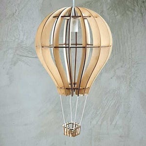 May include: A wooden hot air balloon pendant light fixture with a white cord and a small wooden basket.