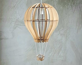 May include: A wooden hot air balloon pendant light fixture with a white cord and a small wooden basket.