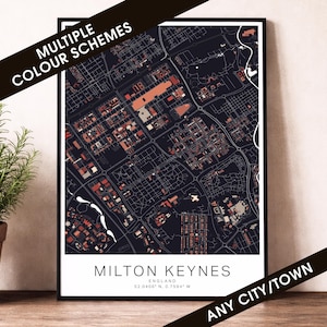May include: A framed map print of Milton Keynes, England, featuring a dark colour scheme with red and orange highlights. The print includes the city's name and coordinates. Text on the image reads "MULTIPLE COLOUR SCHEMES" and "ANY CITY/TOWN".