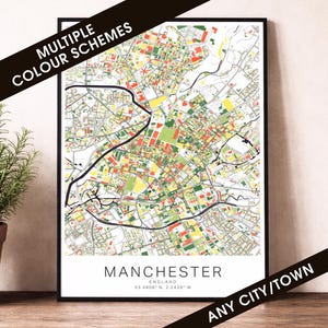 May include: A framed map print of Manchester, England, showing a detailed street layout in various colours. The map includes the text "Manchester" and "Any City/Town". The words "Multiple Colour Schemes" are also visible. The map is a vibrant piece of wall art.