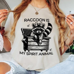 Raccoon Spirit Animal T-Shirt, Cute Dumpster Raccoon with Bow, Unisex Softstyle Top, Trash Panda, Cute Raccoon Shirt, Dumpster Raccoon Shirt