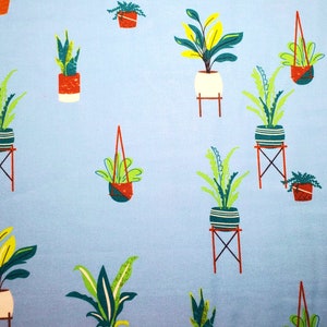 May include: A light blue fabric with a repeating pattern of potted plants. The plants are in various colors and styles, including green, yellow, and red. The pots are also in various colors and styles, including white, red, and blue.