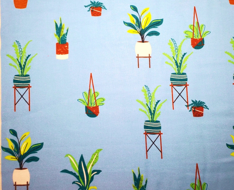 May include: A light blue fabric with a repeating pattern of potted plants. The plants are in various colors and styles, including green, yellow, and red. The pots are also in various colors and styles, including white, red, and blue.