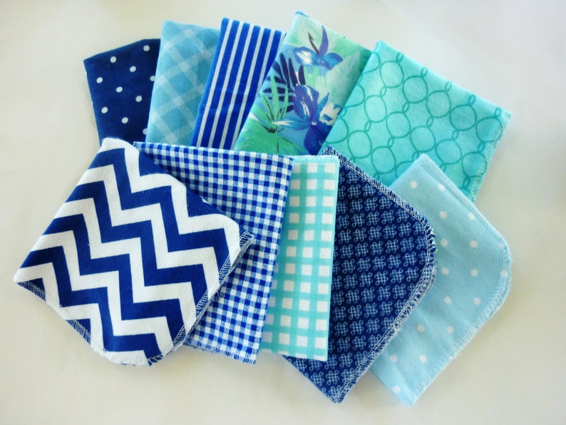 A stack of 10 blue reusable paper towels in a variety of blue and white patterns.  Patterns include dot, gingham, stripe, Hawaiian floral, keyhole, chevron, tiny medallion.