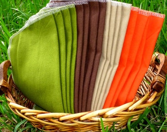 May include: A wicker basket filled with fabric swatches in various colours, including green, brown, beige, and orange.