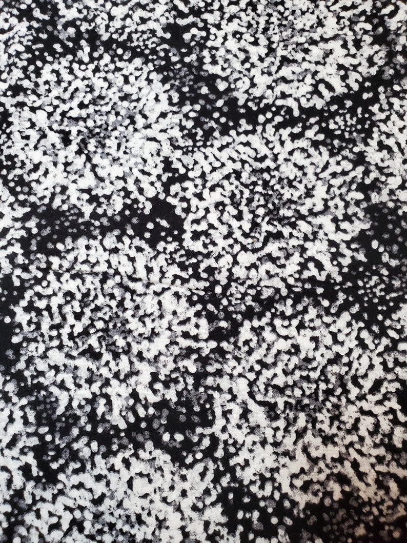 May include: Black and white abstract pattern with a speckled, textured effect. The pattern is made up of small white dots and swirls on a black background.