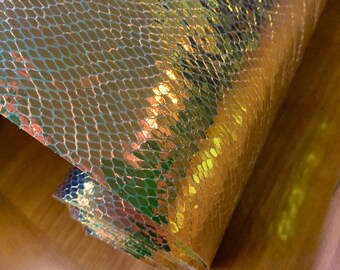 A single 1-yard cut of vinyl fabric, holographic, very unique gold finish. Note shipping details.