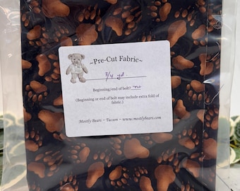 A single 3/4-yard precut of 100 percent cotton fabric Bear Tracks on Black Background.