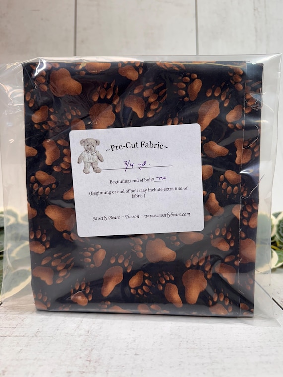 A single 3/4-yard precut of 100 percent cotton fabric Bear Tracks on Black Background.