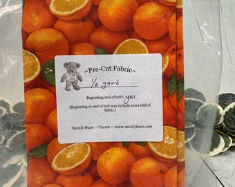 A 1/2-yard precut of 100 percent cotton fabric with oranges all over.