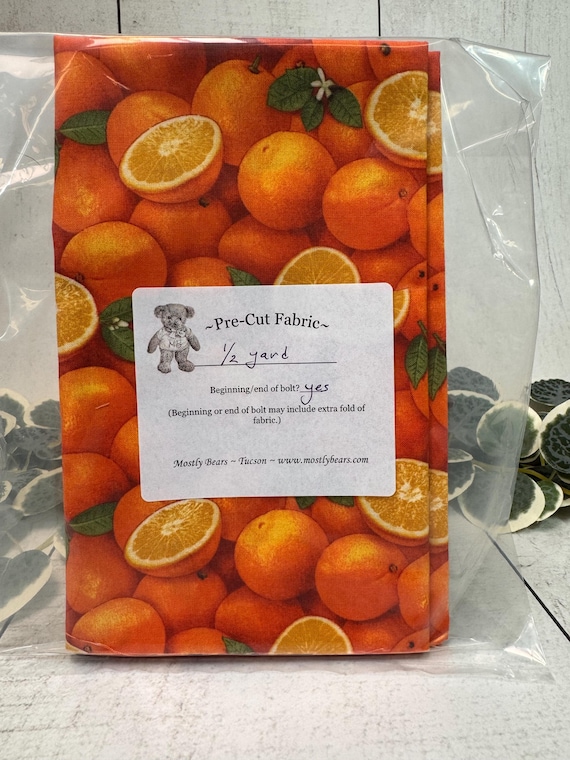 A 1/2-yard precut of 100 percent cotton fabric with oranges all over.