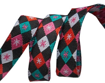 3/8-inch woven jacquard ribbon, argyle and stars on black background.
