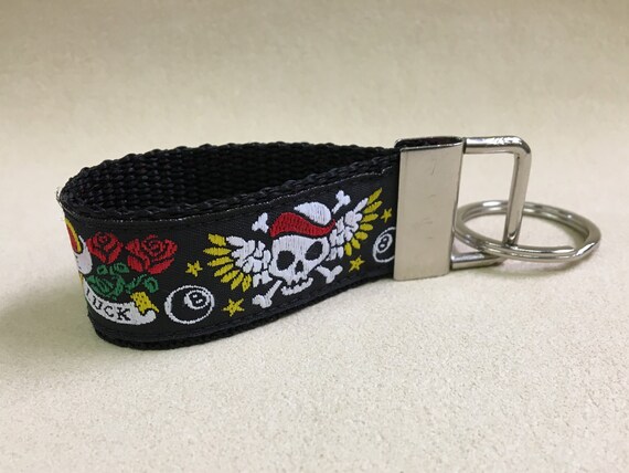A key fob, gorgeous jacquard ribbon with webbing. Tattoo design on black. Small size.