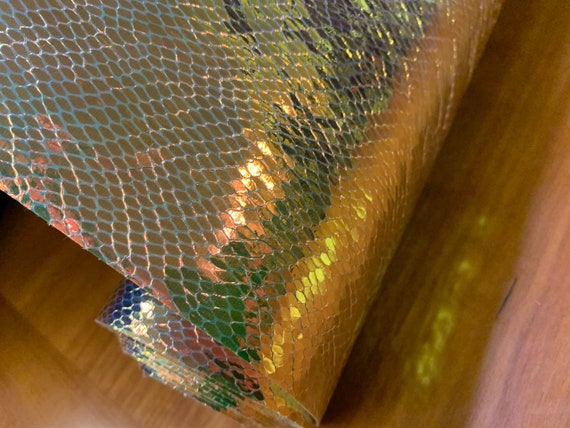 A single 1-yard cut of vinyl fabric, holographic, very unique gold finish. Note shipping details.