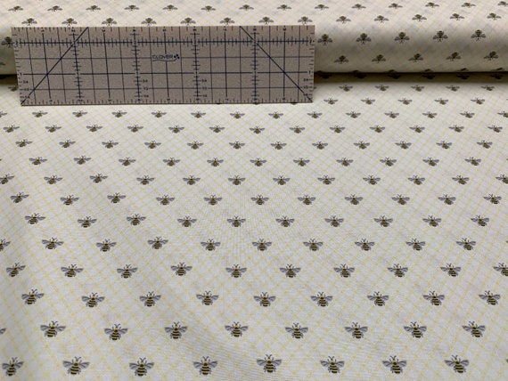 100 percent cotton fabric, bees on pale yellow. Quantity 1= fat quarter. Greater than 1 is a continuous cut. *See note about color!