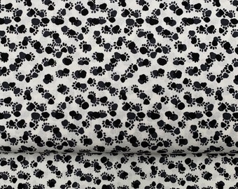 100 percent cotton fabric White with Black Paw prints. Quantity 1= fat quarter. Greater than 1 is a continuous cut.