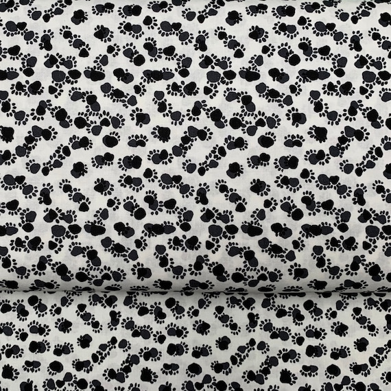 100 percent cotton fabric White with Black Paw prints. Quantity 1= fat quarter. Greater than 1 is a continuous cut.