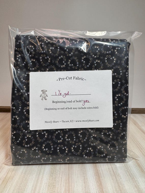 A single 1-1/3 yard precut of 100 percent cotton fabric, hearts and paw prints.