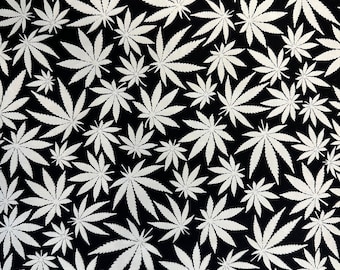 100 percent cotton novelty fabric, glow in the dark, cannabis leaf design.