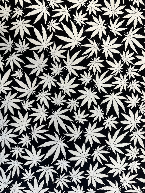 100 percent cotton novelty fabric, glow in the dark, cannabis leaf design.