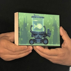 May include: A green and blue pixelated illustration of a robot carrying a fish tank with a single fish inside. The robot is on a green background with pixelated buildings in the background. The text "&copy;ALAN QUIR&Oacute;S" is on the side of the image.