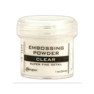 May include: A clear plastic jar of Ranger Super Fine Detail embossing powder. The jar is labeled "Embossing Powder Clear" and "1 oz (34 ml)".