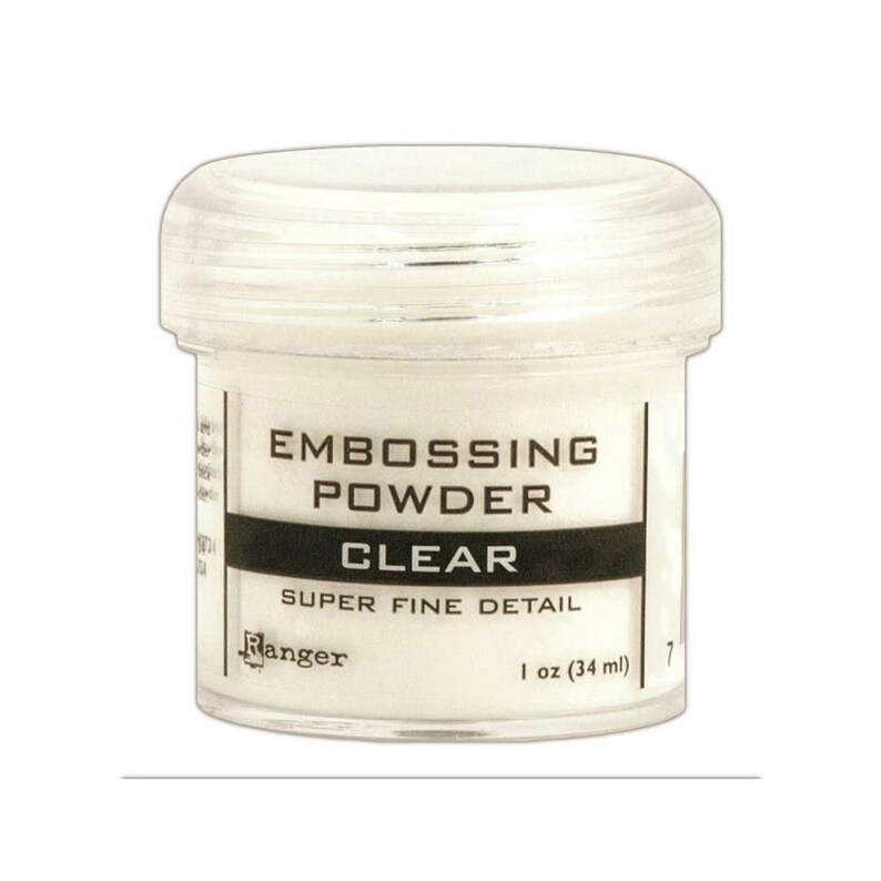 May include: A clear plastic jar of Ranger Super Fine Detail embossing powder. The jar is labeled "Embossing Powder Clear" and "1 oz (34 ml)".