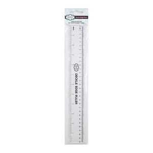 May include: A clear plastic ruler with a scalloped edge for creating unique paper edges. The ruler is 12 inches long and has markings in inches and centimeters. The ruler is packaged in a clear plastic bag with the words "Deckle Edge Ruler" printed on it.