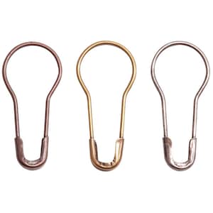 May include: Three open safety pins in copper, gold, and silver tones. Each pin has a teardrop shape with a rounded top and a curved bottom, designed for sewing or crafting projects.