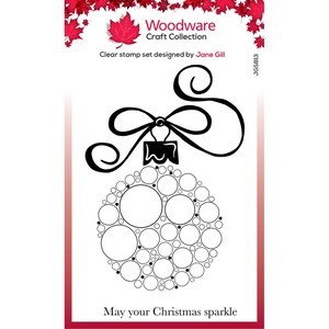 May include: Black and white clear stamp set featuring a Christmas ornament made of circles with a bow on top. The text "May your Christmas sparkle" is at the bottom of the image.